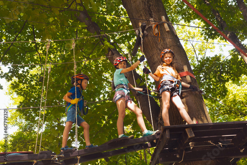 The kids are climbing on the suspension bridge © oksix