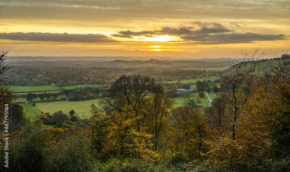 dramatic golden sky and view as the sun sets over Oare village and across Pewsey Vale valley, Marlborough, North Wessex Downs AONB