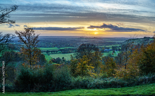 scenic Westerly view as the golden sun sets over Oare and across the Pewsey Vale valley, North Wessex Downs AONB © Martin