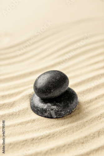 Black spa stones on light sand