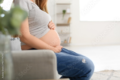 Pregnant woman holding her ...