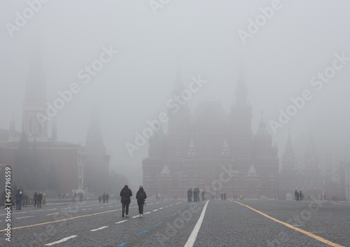 Moscow, Russia, Nov 02, 2021: Heavy fog.  Red square. Nikolskaya tower and Historical museum hidden in fog at background. People walking