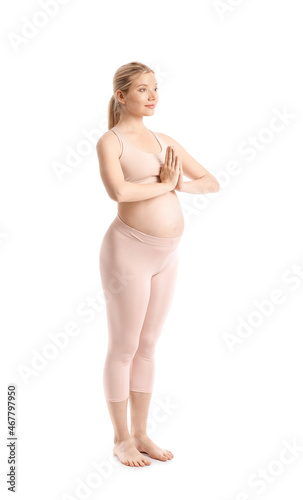 Young pregnant woman meditating on white background