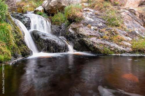 Small water wall and a pool of water. Beautiful nature landscape scene. Dark and moody tone.