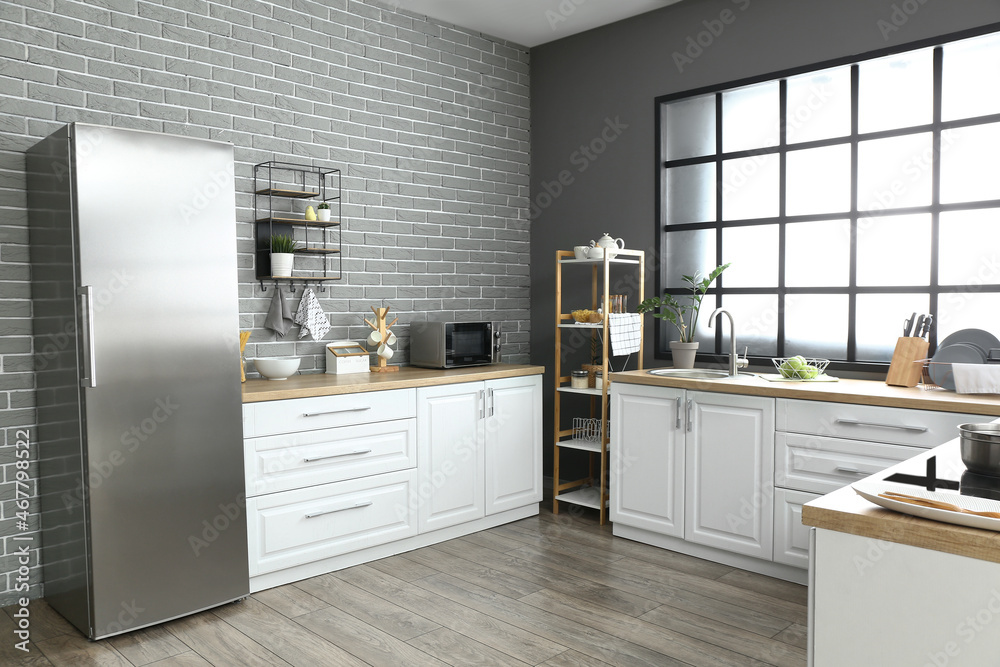 Interior of modern kitchen with fridge and white counters Stock Photo ...
