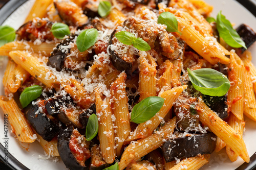 Pasta alla Norma with eggplant or aubergine, tomato, parmesan and basil. Healthy food photo