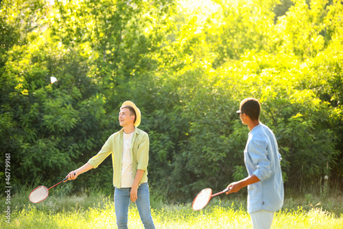 Young men playing badminton...