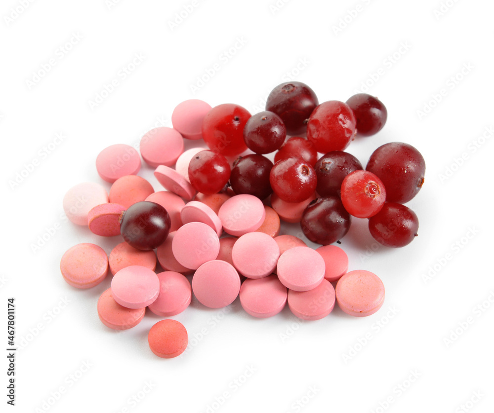 Heap of cranberry pills and berries on white background Heap of cranberry pills and berries on white background