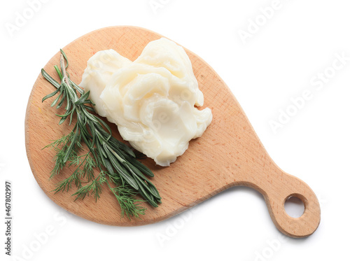 Board with lard and herbs on white background