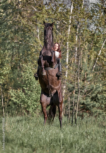 Beautiful long-haired girl riding a horse