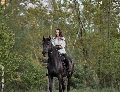 Beautiful long-haired girl riding a horse