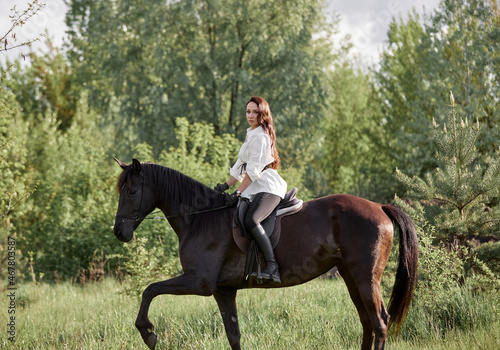 Beautiful long-haired girl riding a horse © Елизавета Мяловская