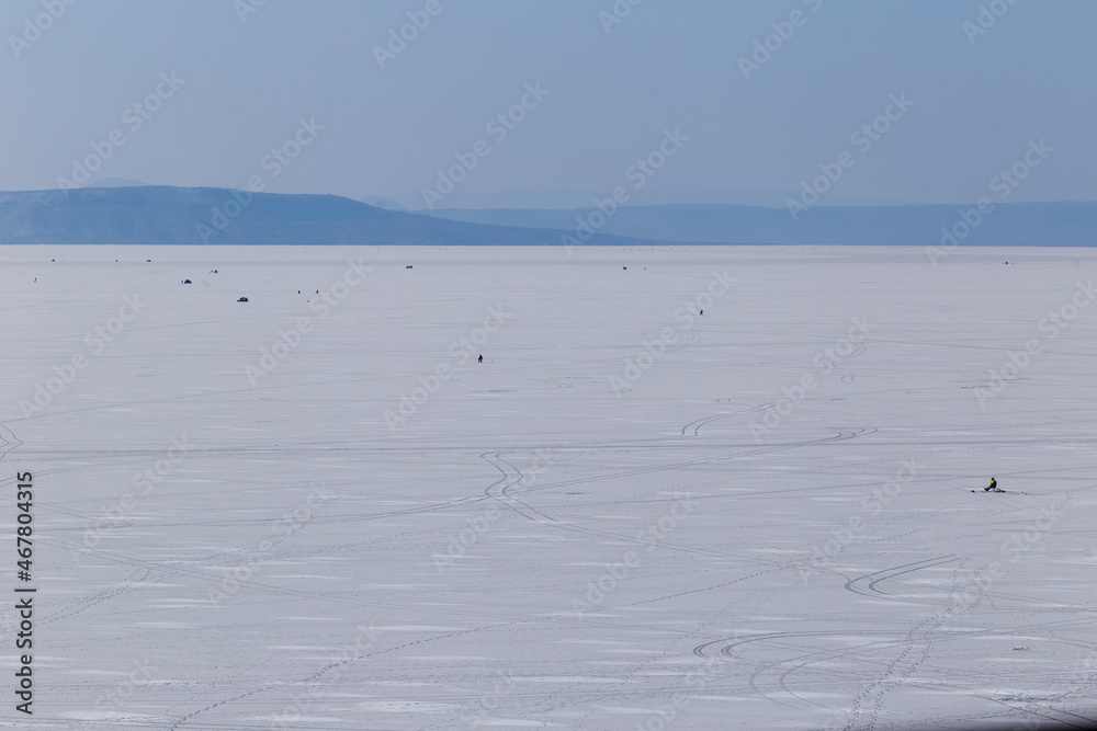 Winter sea fishing in Vladivostok. Frozen Amur Bay with fishermen. Winter sea fishing in Vladivostok. Frozen Amur Bay with fishermen.