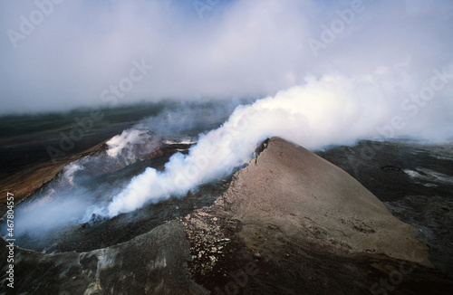 The Caldera Mouth of a Volcano in Hawaii with Steam Rising out of it as Seen from a Helicopter Above