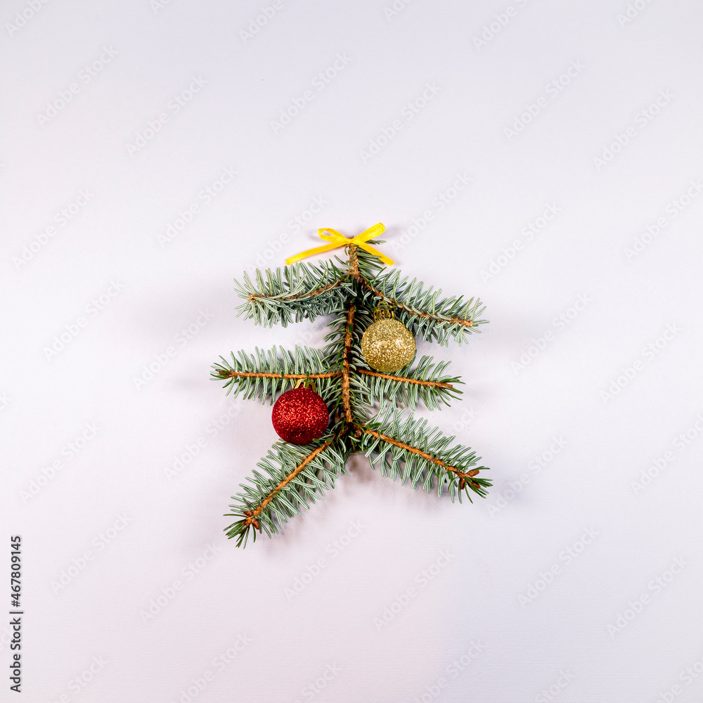 Pine branch with Christmas baubles and ornamental ribbon. Flat lay, top view. Minimal abstract winter holidays concept. Copy space. Pine branch with Christmas baubles and ornamental ribbon. Flat lay, top view. Minimal abstract winter holidays concept. Copy space.