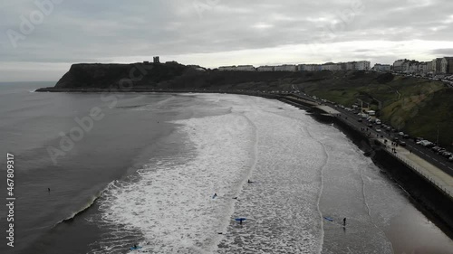 Drone footage of surfers paddling out to ride waves in Scarborough, North Yorkshire, UK. 15.10.21 photo