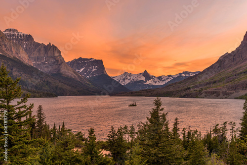 Sunset at Saint Mary Lake - A panoramic spring sunset view of Saint Mary Lake and its surrounding steep mountains, seen from Going-To-The-Sun Road, in Glacier National Park, Montana, USA. photo