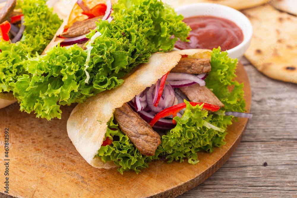 Pita with salad , paprika and beef meat Pita with salad , paprika and beef meat