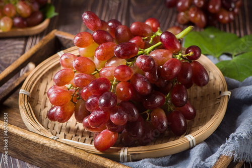 fresh ripe red seedless grapes  on wood table