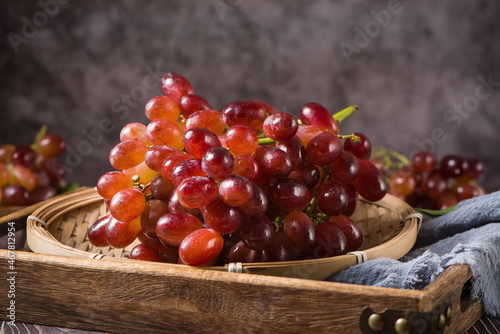 fresh ripe red seedless grapes on wood table