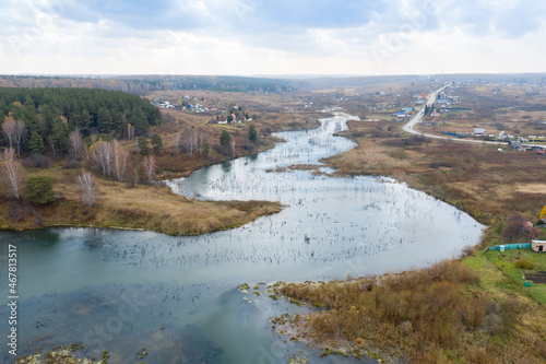 Aerial view of the winding river and farm near the village of Karpysak in Siberia in autumn
