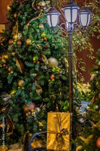 Christmas scene with old fashoned lamp post, presents and decorated christmas tree photo