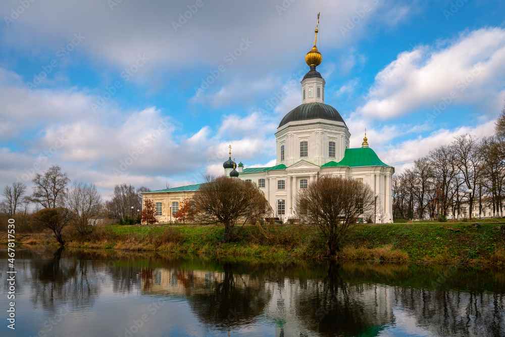 View of the Vyazma Museum of Local History located in the Bogoroditskaya Church on the banks of the Vyazma River on a sunny autumn day with clouds, Vyazma, Smolensk region, Russia
