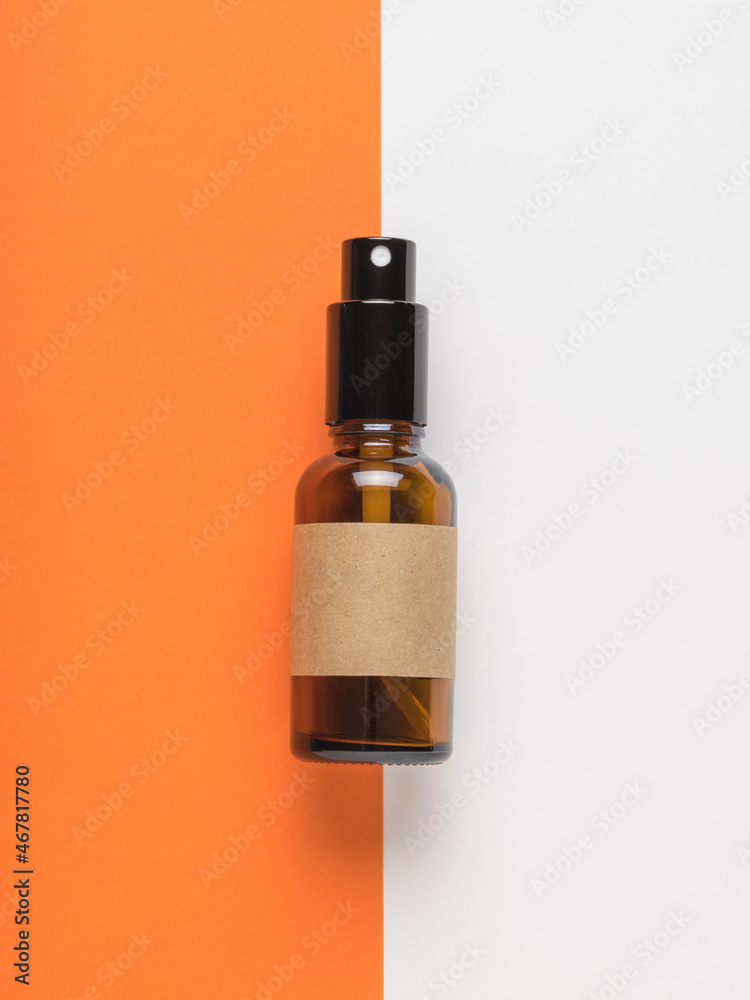 A spray bottle on a white and orange background. A spray bottle on a white and orange background.