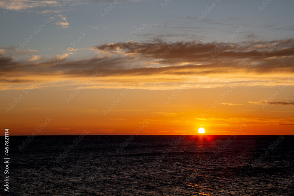 The sun sets over the sea at sunset