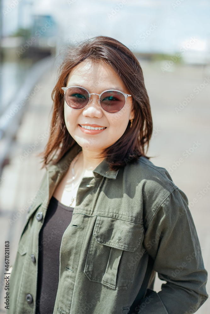 Young Beautiful Asian Woman Wearing Jacket And Black Jeans Posing Outdoors Young Beautiful Asian Woman Wearing Jacket And Black Jeans Posing Outdoors