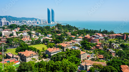 Overlooking ancient buildings in Gulangyu, and modern buildings along the coast of Xiamen, China. photo