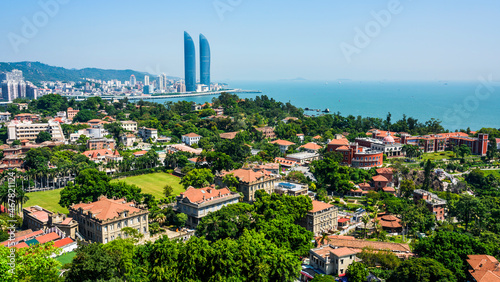 Overlooking ancient buildings in Gulangyu, and modern buildings along the coast of Xiamen, China.