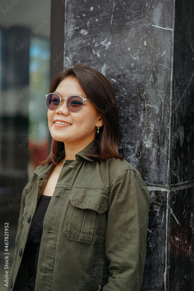 Young Beautiful Asian Woman Wearing Jacket And Black Jeans Posing Outdoors Young Beautiful Asian Woman Wearing Jacket And Black Jeans Posing Outdoors