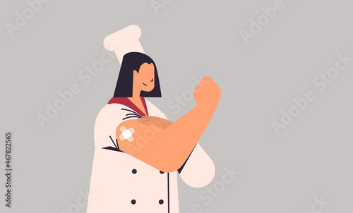 vaccinated woman chef in uniform after vaccine injection successful covid-19 vaccination horizontal portrait