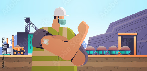 vaccinated workman engineer in protective helmet after vaccine injection successful covid-19 vaccination industrial mining