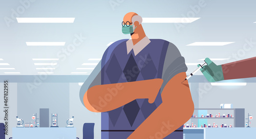 doctor hand vaccinating senior male patient in medical mask fight against coronavirus vaccine development concept