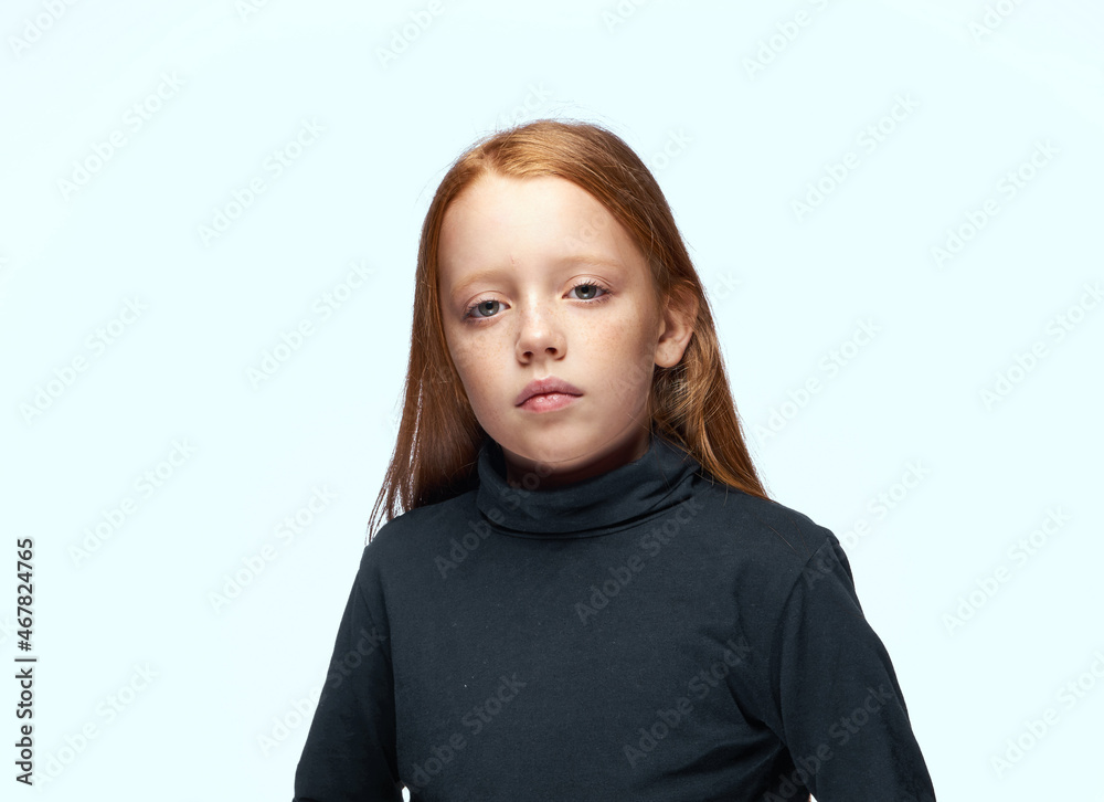 red-haired girl in a black sweater planning close-up