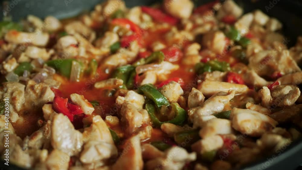 Homemade fajita mix simmering in a frying pan - bell peppers, chicken, beans, spices, onion recipe Homemade fajita mix simmering in a frying pan - bell peppers, chicken, beans, spices, onion recipe