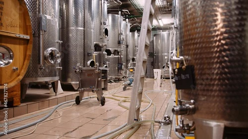 Massive stainless steel wine fermentation tanks in modern wine-cellar photo