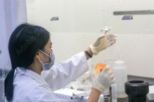 Asian woman scientist making an experiment in the laboratory