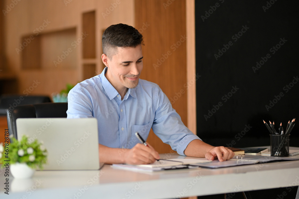 Handsome caucasian businessman work and write on paperwork. Handsome caucasian businessman work and write on paperwork.