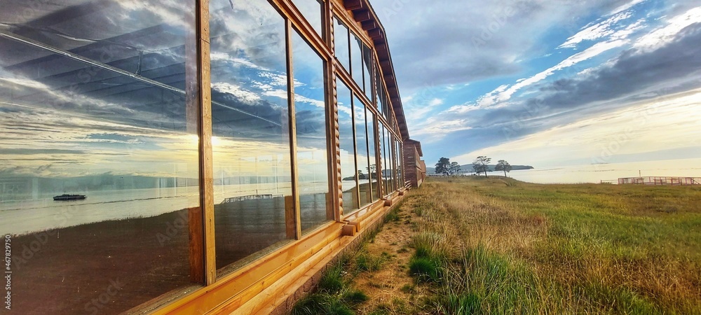 Beautiful reflection of the sky and fhe lake in the panoramic windows. Beautiful reflection of the sky and fhe lake in the panoramic windows.
