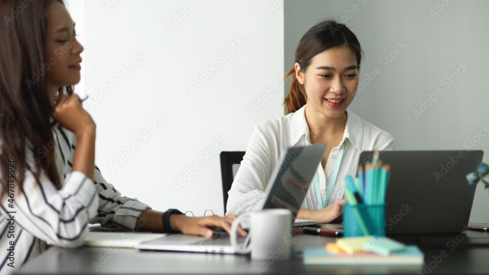 Female manager working with her female employee Female manager working with her female employee
