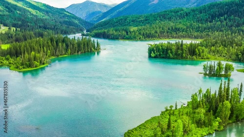 Aerial view of kanas Lake in Summer,Xinjiang,China.Green forest and mountain with river.A famous tourist destination in China. photo