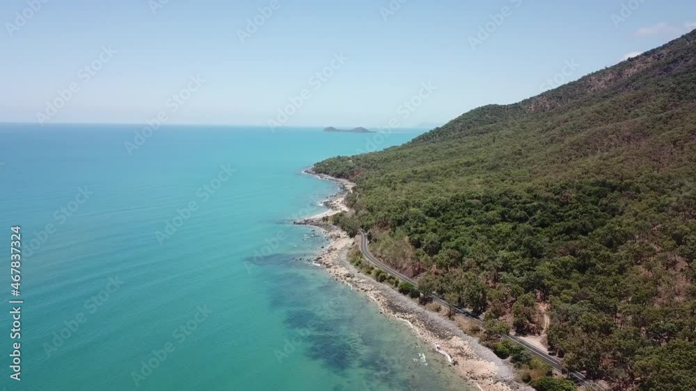 Drone aerial high over tropical blue water and highway with cars Drone aerial high over tropical blue water and highway with cars