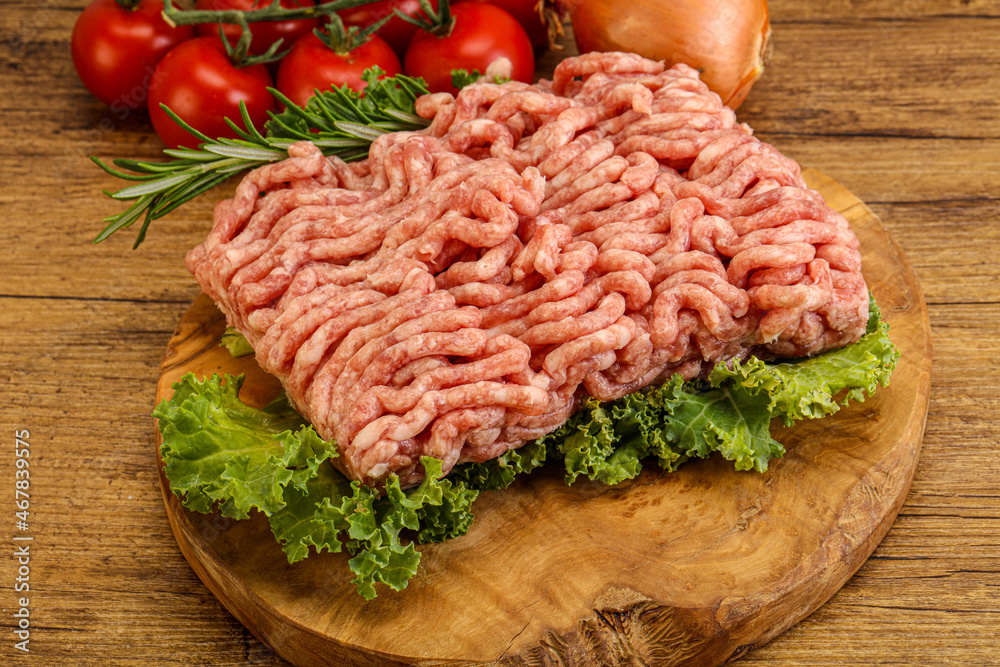 Raw pork minced meat over board Raw pork minced meat over board