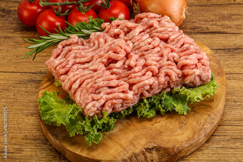 Raw pork minced meat over board