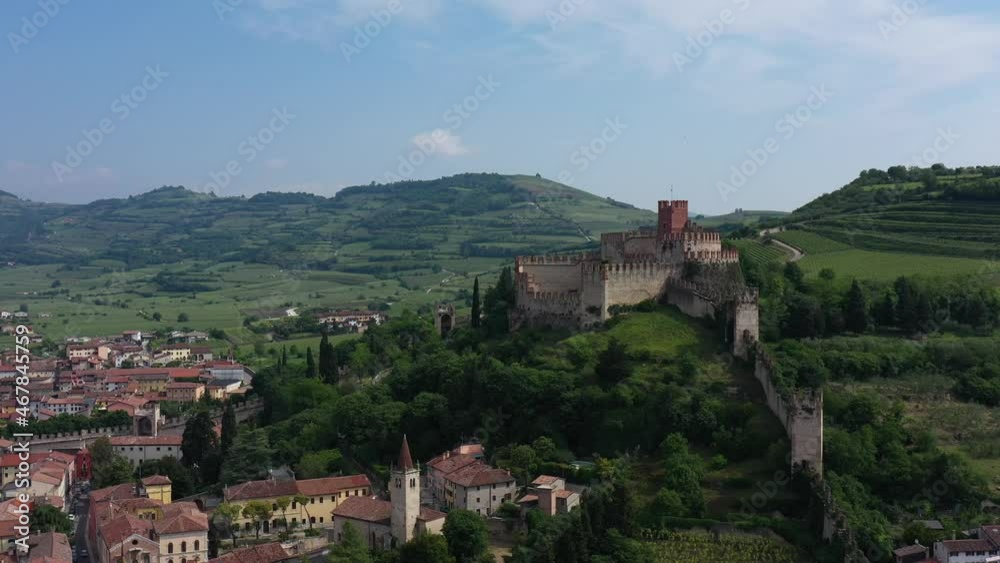 Aerial panorama of the castles of Italy. Aerial view, slow flight over Soave castle, Verona province, Italy. Italian historic castles. The famous medieval castle on the hill. Aerial panorama of the castles of Italy. Aerial view, slow flight over Soave castle, Verona province, Italy. Italian historic castles. The famous medieval castle on the hill.