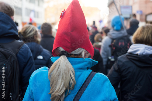 Portrait on back view of woman wearing a french revolutionary hat in the street