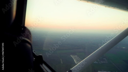 A propeller plane flight, view out of a window, skyline, sunset, golden hour, passenger point of view, nice weather, smooth flight, cinematic shot photo